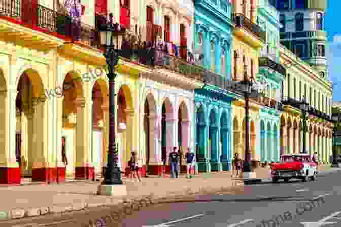 A Colorful Street In Havana, Cuba, Lined With Pastel Colored Buildings And Vintage Cars Cuba Going Back Tony Mendoza